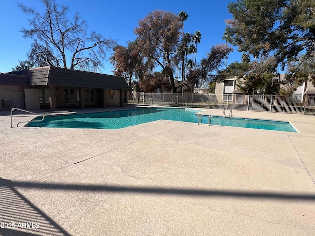 pool featuring a patio and fence