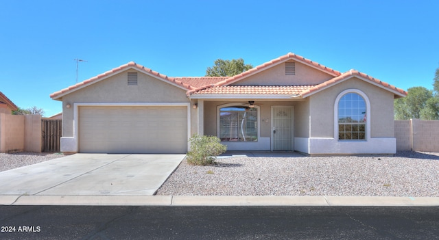 view of front facade with a garage and ceiling fan