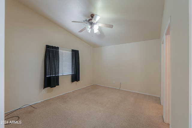 unfurnished room featuring light carpet, ceiling fan, and vaulted ceiling