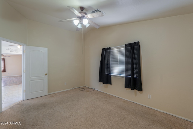 spare room featuring light colored carpet and ceiling fan