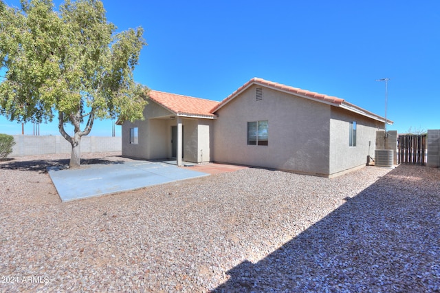 rear view of property featuring a patio area and central AC