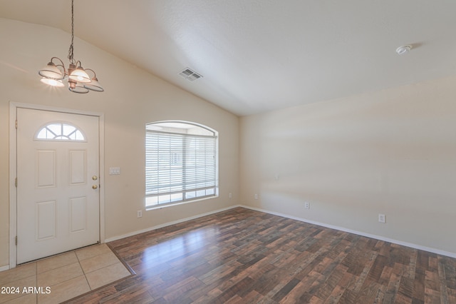 foyer featuring a chandelier, wood-type flooring, and high vaulted ceiling