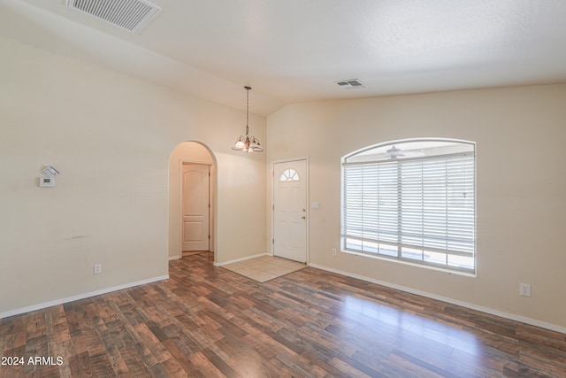 foyer featuring lofted ceiling, hardwood / wood-style floors, and ceiling fan with notable chandelier