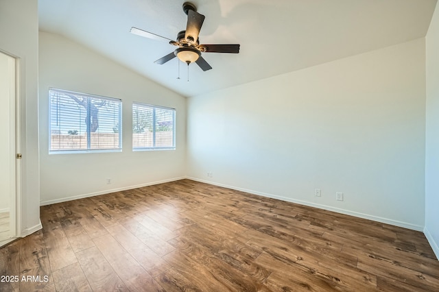 empty room featuring ceiling fan, lofted ceiling, and dark hardwood / wood-style flooring