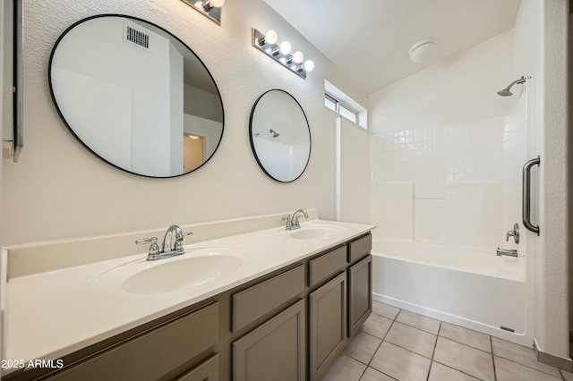 bathroom featuring tile patterned flooring, vanity, vaulted ceiling, and shower / bathtub combination