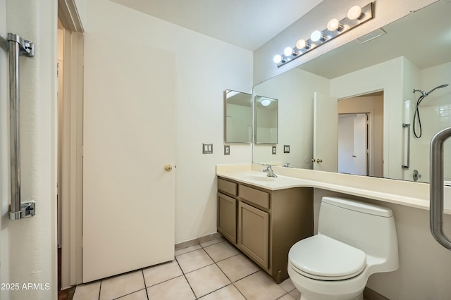 bathroom featuring tile patterned flooring, vanity, a shower, and toilet