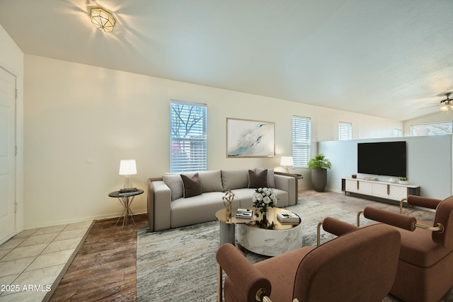 tiled living room featuring a wealth of natural light and ceiling fan