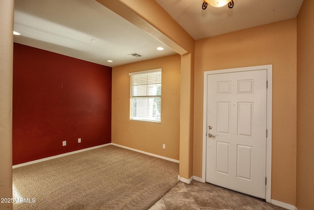 view of carpeted foyer entrance