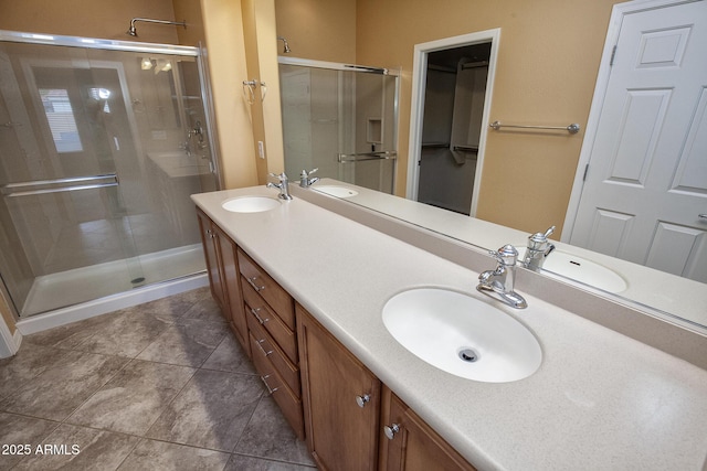 bathroom with vanity, tile patterned flooring, and a shower with door