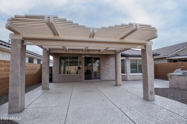 back of property featuring a pergola and a patio area