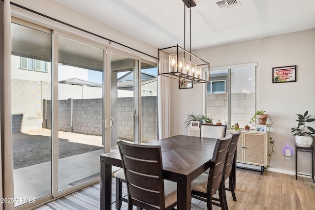 dining space featuring plenty of natural light and light wood-type flooring