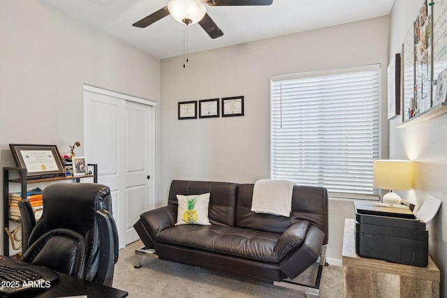 carpeted home office featuring ceiling fan and a healthy amount of sunlight