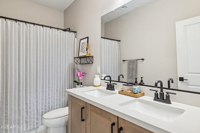 bathroom with toilet, vanity, and walk in shower