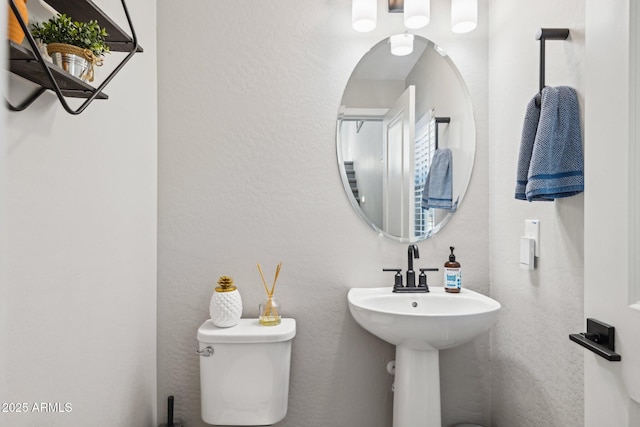 bathroom featuring toilet and sink