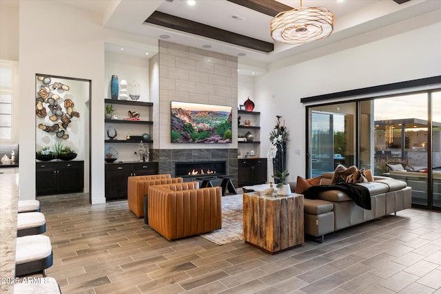 26690 N 119th St, Scottsdale, AZ 85262 - living area featuring a high ceiling, beamed ceiling, visible vents, a fireplace, and wood tiled floor