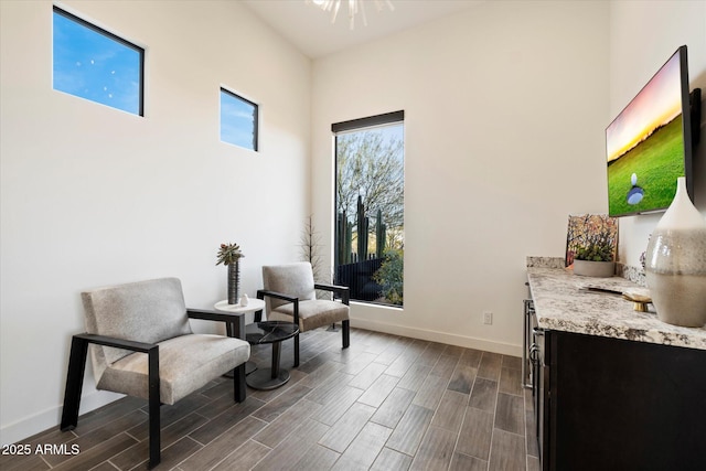 26690 N 119th St, Scottsdale, AZ 85262 - sitting room featuring baseboards, a towering ceiling, and wood finish floors