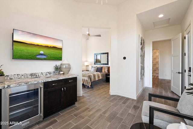 26690 N 119th St, Scottsdale, AZ 85262 - bedroom with baseboards, a bar, wine cooler, wood finish floors, and attic access