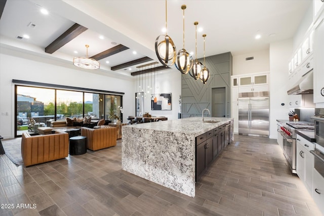 26690 N 119th St, Scottsdale, AZ 85262 - kitchen featuring open floor plan, under cabinet range hood, a sink, beam ceiling, and premium appliances