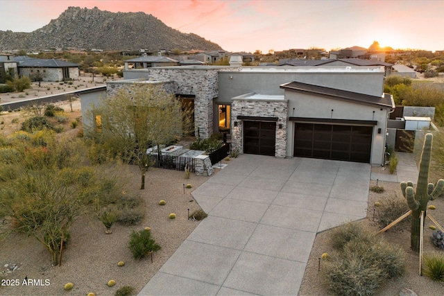 26690 N 119th St, Scottsdale, AZ 85262 - modern home with stone siding, concrete driveway, stucco siding, a garage, and a mountain view