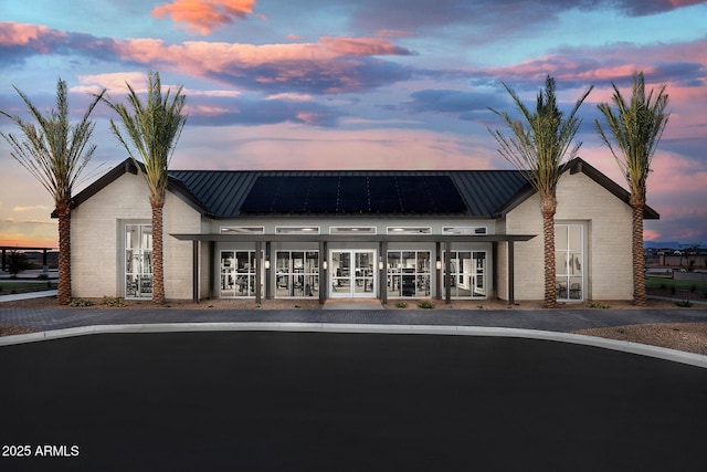 view of outdoor building at dusk