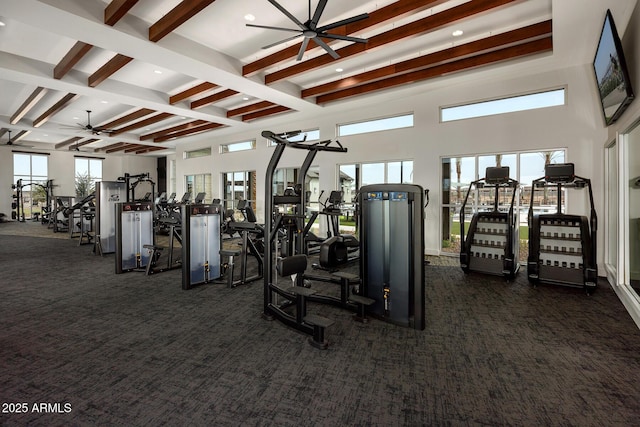 gym with ceiling fan, coffered ceiling, and dark carpet