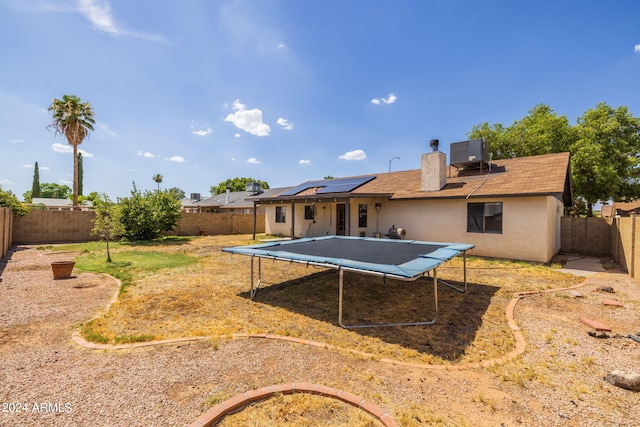 view of yard featuring central AC unit and a trampoline