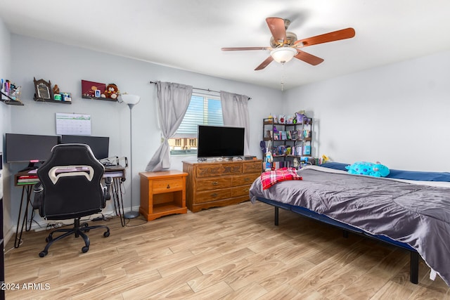 bedroom with light hardwood / wood-style flooring and ceiling fan