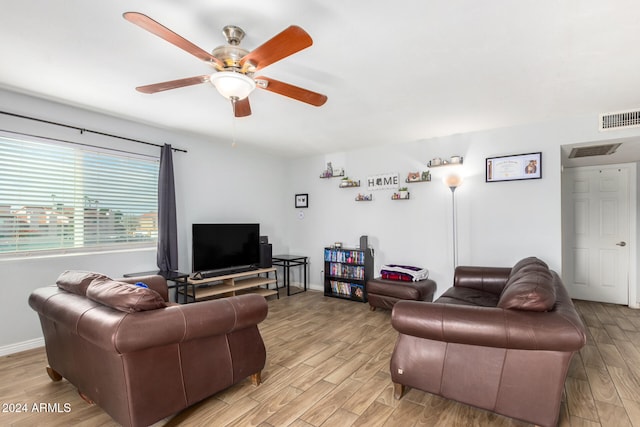 living room with ceiling fan and light hardwood / wood-style flooring