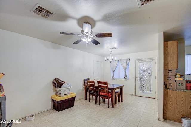 dining room with ceiling fan with notable chandelier and visible vents