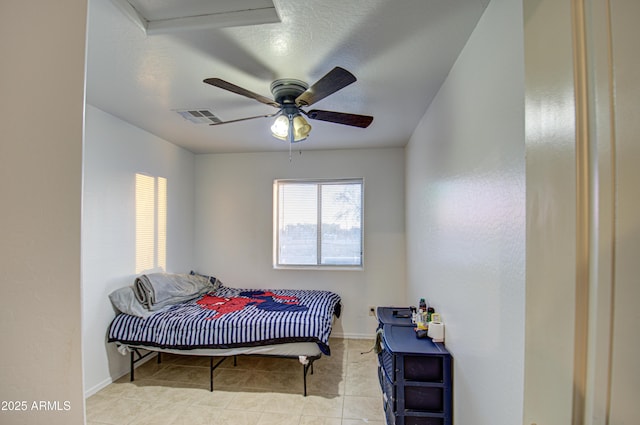 bedroom featuring tile patterned flooring, visible vents, baseboards, and a ceiling fan