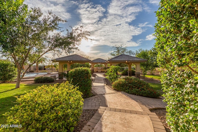 view of community with a lawn and a gazebo