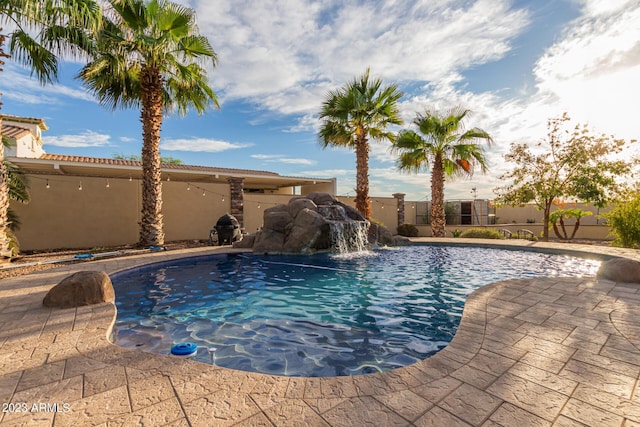 view of swimming pool with a patio area, fence, and a fenced in pool