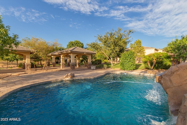 pool with a patio and a gazebo