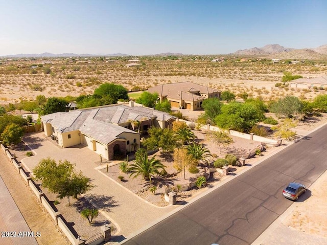 bird's eye view with a desert view and a mountain view