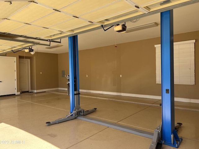 garage with baseboards and a garage door opener