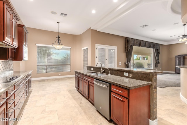 kitchen with decorative light fixtures, visible vents, stainless steel dishwasher, a ceiling fan, and a sink