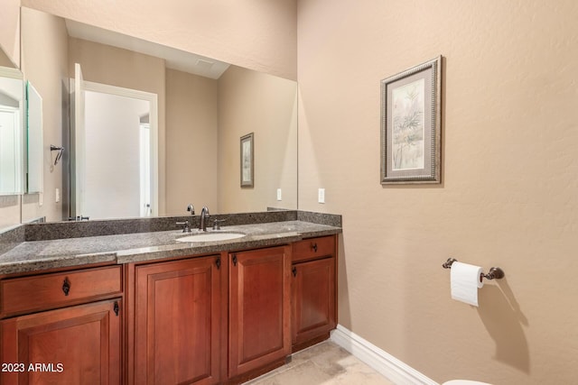 bathroom featuring vanity and baseboards