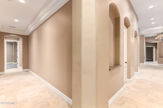 corridor with arched walkways, visible vents, baseboards, and recessed lighting