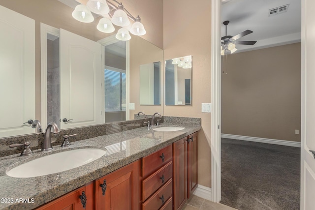 bathroom with ceiling fan, double vanity, a sink, and visible vents