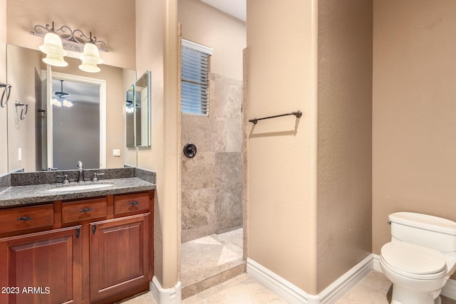 full bath featuring baseboards, toilet, tile patterned flooring, vanity, and a walk in shower