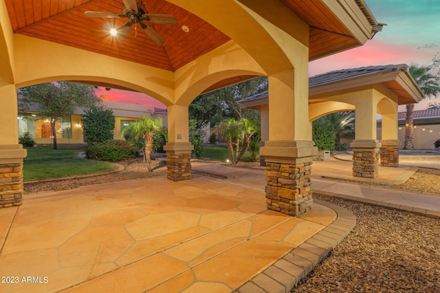 patio terrace at dusk with a ceiling fan