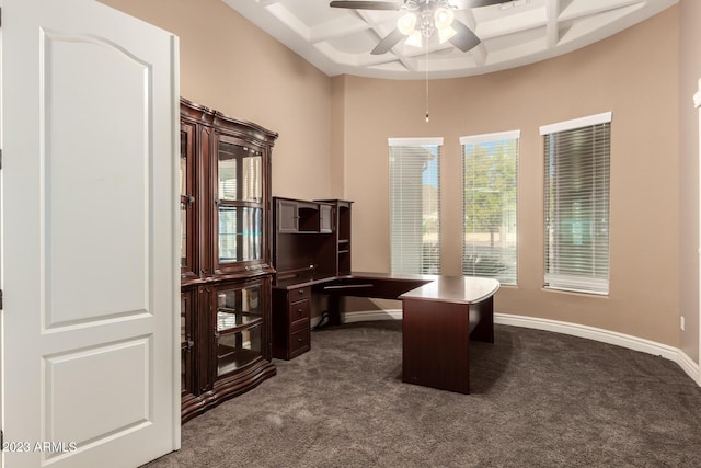 office area with ceiling fan, baseboards, coffered ceiling, and dark colored carpet