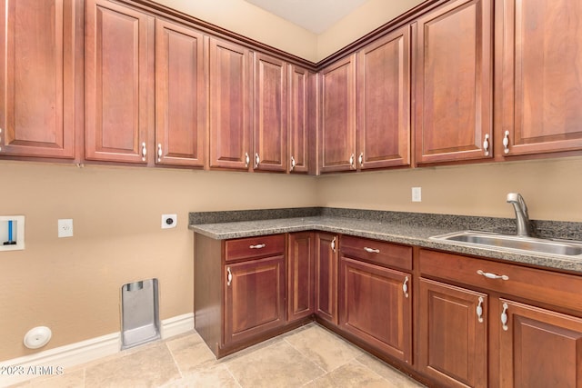 washroom with light tile patterned floors, hookup for a washing machine, cabinet space, hookup for an electric dryer, and a sink