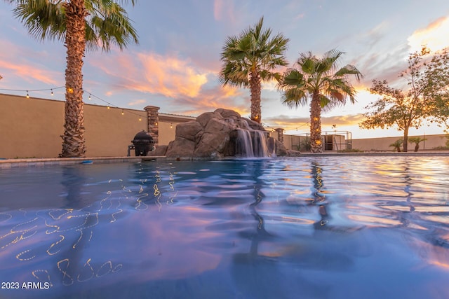 view of pool at dusk