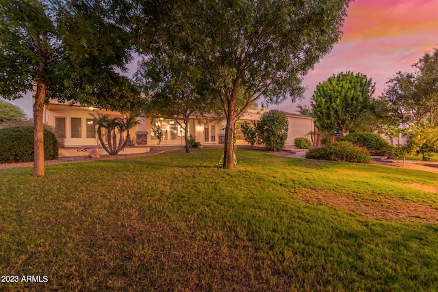 view of front facade featuring a yard and stucco siding