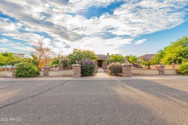 view of front of property with a fenced front yard and a gate