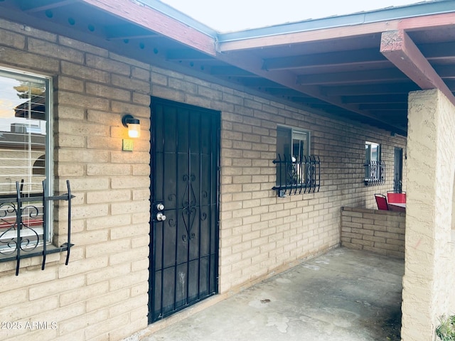 property entrance featuring brick siding