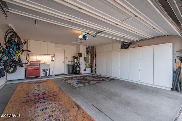 garage with a garage door opener and sink