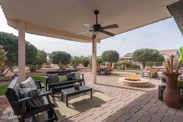 view of patio / terrace featuring an outdoor living space with a fire pit and ceiling fan