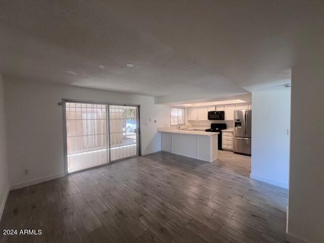 4332 W Ocotillo Rd Unit 206, Glendale, AZ 85301 - unfurnished living room featuring wood finished floors and baseboards